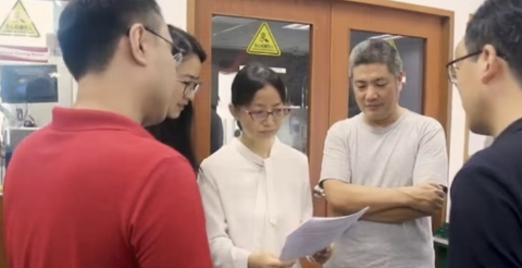 Engineering team reviewing optical design specifications